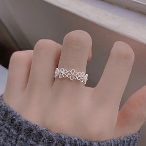 Minimalist S925 sterling silver hollow flower open ring worn on finger with soft background