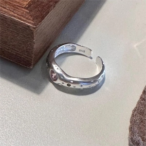 Detail view of S925 sterling silver ring showing irregular texture and silver hallmark