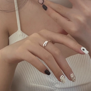 Detail of S925 sterling silver Mobius ring worn on hand showing woven open design