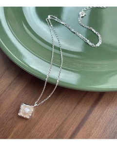Macro shot of S925 silver necklace with irregular frame and round freshwater pearl