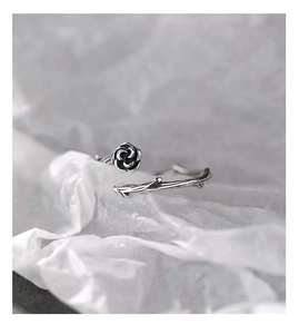 Detailed macro shot of vintage silver S925 thorn rose ring on white background texture