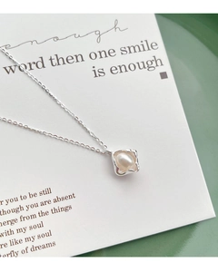 Detail of S925 silver necklace with square pearl pendant on elegant background