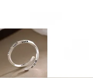 Detailed macro shot of S925 sterling silver ring featuring Luck engraving and Mobius twist