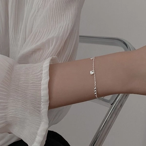 Elegant S925 sterling silver heart bracelet with sparkling stones on female wrist