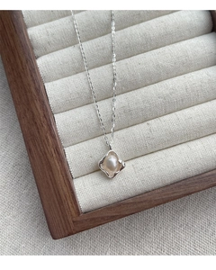 Macro shot of S925 sterling silver necklace with freshwater pearl on a vintage tray