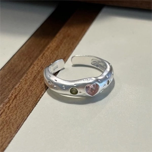 Macro shot of S925 sterling silver ring with pink heart stone and matte irregular texture