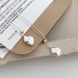 Minimalist S925 sterling silver necklace with irregular lava pendant and gold accent bead