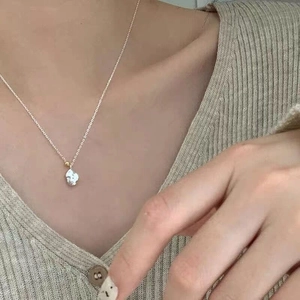 Detail of S925 silver irregular meteorite pendant necklace on female model's collarbone