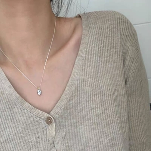 Detailed close-up of a minimalist S925 sterling silver irregular meteorite necklace