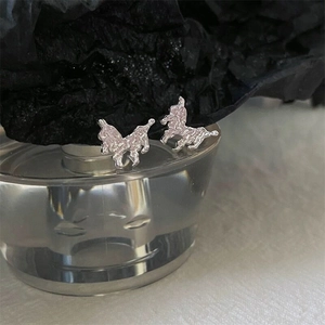 Detailed macro view of S925 silver stud earrings with irregular lava texture design