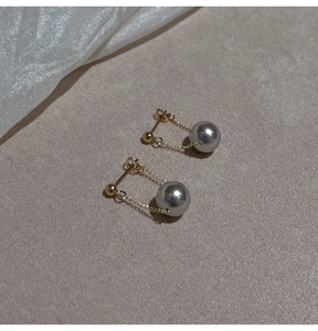 Detailed macro view of S925 sterling silver chain earrings with elegant grey pearls