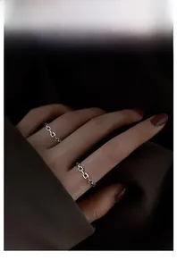 Close-up of minimalist S925 sterling silver chain ring set worn on finger with textured link