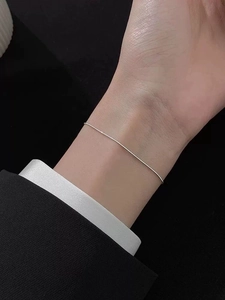 Close-up of a delicate S925 sterling silver snake bone chain bracelet on a wrist