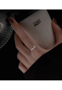 Detail of S925 sterling silver chain ring on index finger with polished Cuban link texture