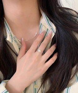 Close-up of a minimalist S925 silver adjustable ring with a glossy white freshwater pearl