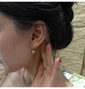 Elegant drop pearl earring with gold chain on model showing sophisticated look