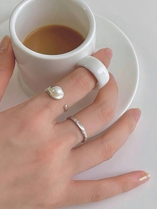 Detailed close-up of S925 silver pearl ring set with handmade hammered texture on a hand