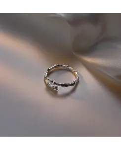 Detailed macro view of the silver pleated foil texture on the adjustable open ring