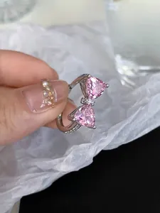 Detailed macro view of S925 silver ring featuring pink heart-shaped stones in bow design
