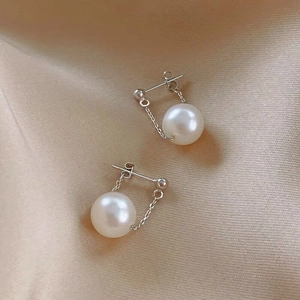 Minimalist S925 silver pearl drop earrings with round white pearls on silk background