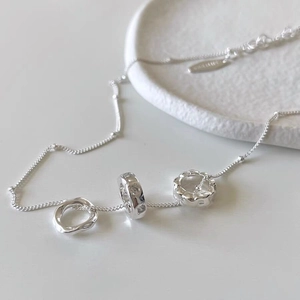 Detailed macro view of S925 silver necklace featuring three unique interlocking circle pendants