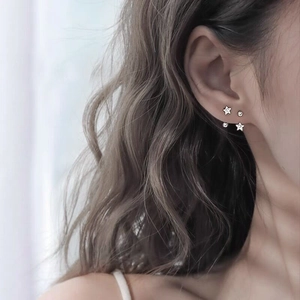 Minimalist S925 sterling silver star screw back stud earrings on model's ear