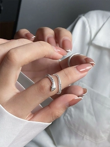 Close-up of S999 silver snake ring with scale texture and adjustable open design