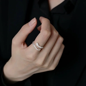 Detailed close-up of a sterling silver snake ring with scales on a woman's finger