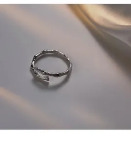 Macro detail of silver S925 sterling silver ring with branch texture and open band design
