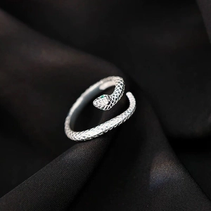 Close-up of S999 sterling silver snake ring featuring green gem eyes and scale texture