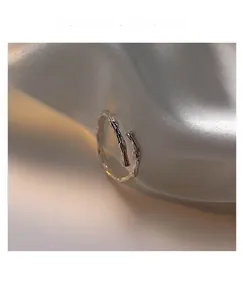 Macro detail of S925 sterling silver open ring with bionic bamboo texture on silk