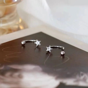 Elegant S925 sterling silver star earrings with white zircon on a dark artistic background