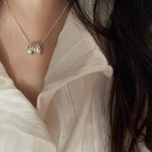Minimalist S925 sterling silver triple ring necklace on model with white shirt