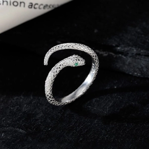 Minimalist S925 sterling silver snake ring with green gemstone on black stone background