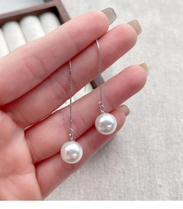 Detailed close-up of S925 sterling silver drop earrings with lustrous white pearls