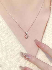 Close-up of S925 silver cherry blossom necklace with pink gemstone on a model neck