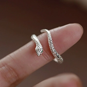 Minimalist S999 sterling silver snake open ring with green gem eyes on finger