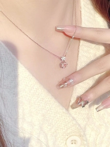 Elegant rose gold S925 silver necklace with pink cherry blossom pendant on a female model