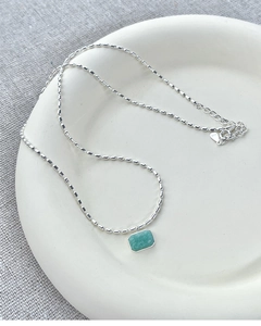 Detail shot of rectangular green gemstone pendant on S925 sterling silver chain