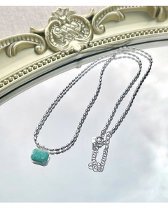 Detailed macro view of S925 silver necklace with rectangular amazonite stone on mirror