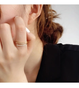Detail of S925 silver double layer ring with elegant white pearls and zircon pavé