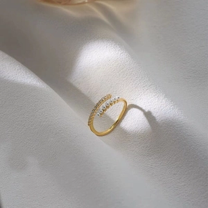 Detail of S925 silver gold-plated ring with rows of pearls and pave-set zircons
