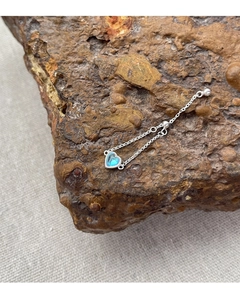 Close-up of heart moonstone silver ring with adjustable chain on natural stone
