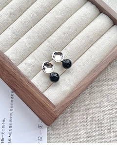 Detailed macro view of S925 silver concave studs with sleek black onyx round beads