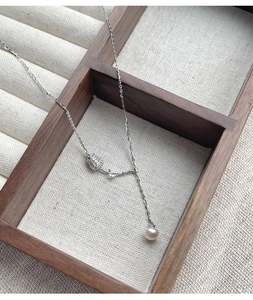 Detailed close-up of S925 silver tulip pendant with inset diamonds and freshwater pearl