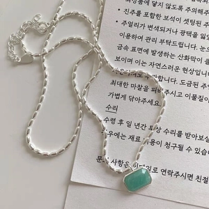 Macro detail of S925 silver necklace featuring a hexagonal green amazonite pendant charm