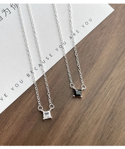 Macro detail of S925 silver necklace with square clear and black zircon pendants
