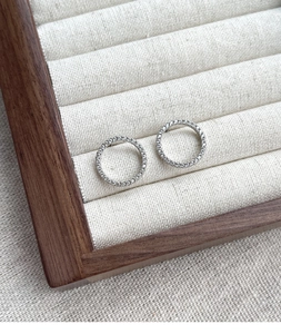 Close-up of S925 sterling silver circle earrings with pavé set cubic zirconia