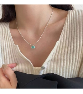 Detailed view of an S925 sterling silver clavicle chain with a green square amazonite pendant