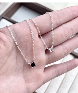 Close-up of S925 silver necklace featuring black and white square-cut zircon pendants